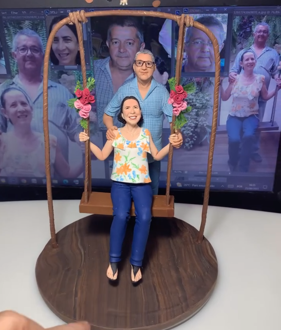 Casal de miniaturas sentado em balanço de madeira decorativo